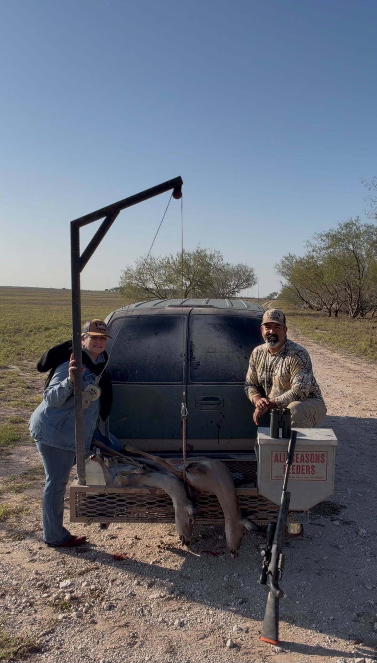 Two hunters with vehicle and feeder system
