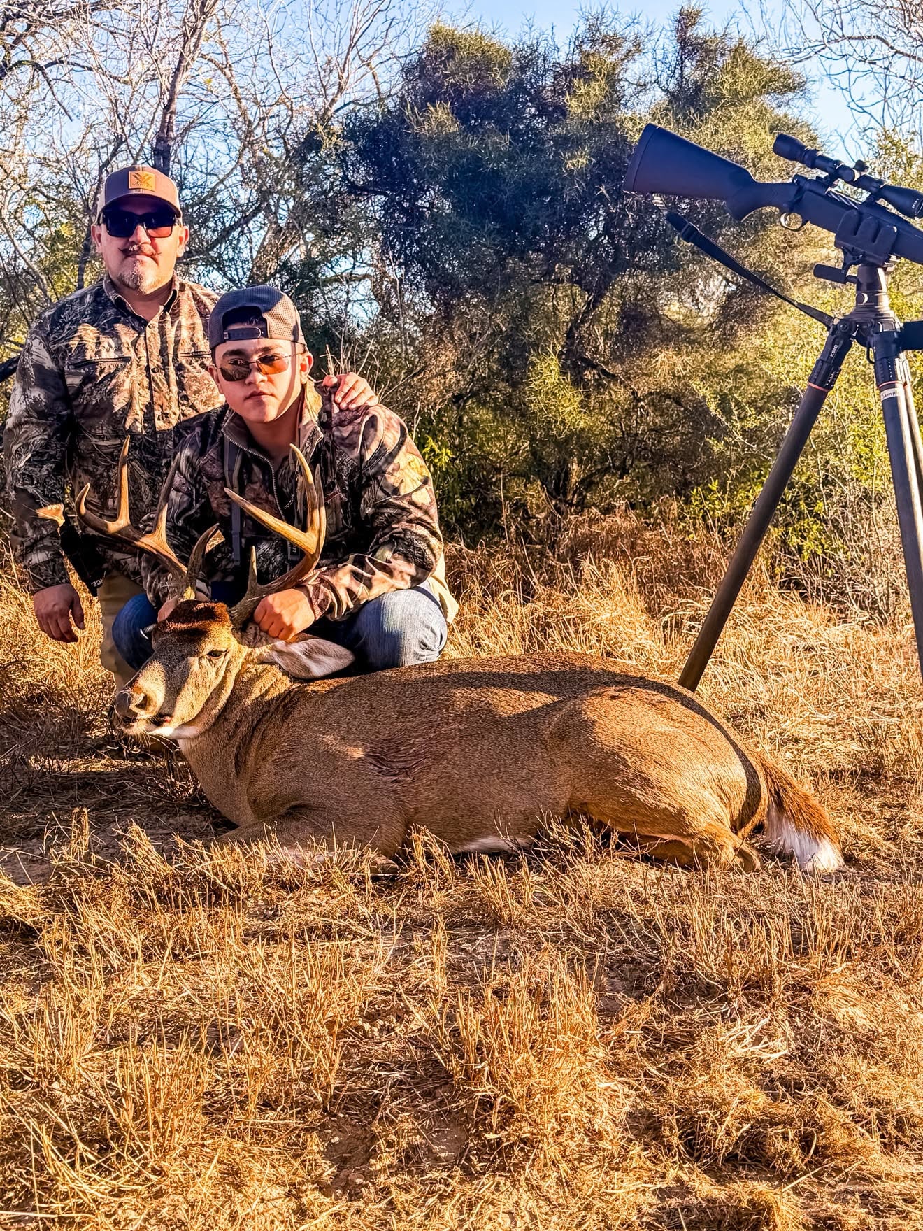Hunters posing with harvested deer