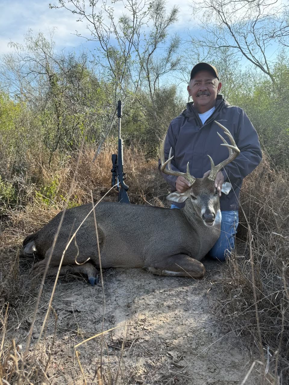 Hunter with harvested whitetail buck South Texas